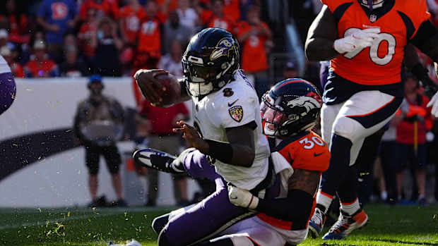 Denver Broncos safety Caden Sterns (30) sacks Baltimore Ravens quarterback Lamar Jackson (8) in the third quarter at Empower Field at Mile High.